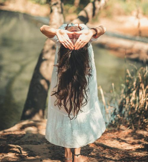 Woman performing a gentle yoga flow pose in a calm environment.